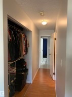 Wood-finish flooring throughout the hallway - 