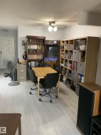 Light wood-finish flooring with a ceiling fan - 