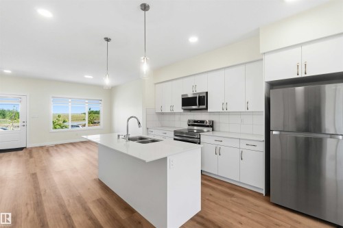 4582 Warbler Loop Nw, Edmonton, AB - Indoor Photo Showing Kitchen With Stainless Steel Kitchen With Double Sink With Upgraded Kitchen