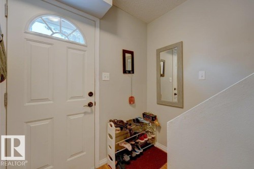 Entry door with an arched transom window, paneled construction, and bronze hardware - 307 Northgate Terrace Nw, Edmonton, AB - Indoor Photo Showing Other Room