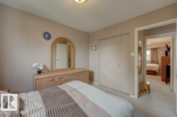 Neutral wall tones, carpeted flooring, and a flush mount ceiling light fixture - 