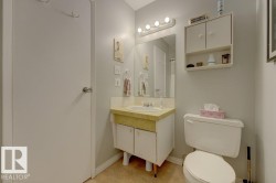 Vanity with integrated sink, mounted mirror, overhead lighting, and wall-mounted storage cabinet - 