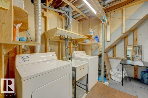 Laundry area with a utility sink, washing machine, and dryer - 307 Northgate Terrace Nw, Edmonton, AB - Indoor Photo Showing Laundry Room