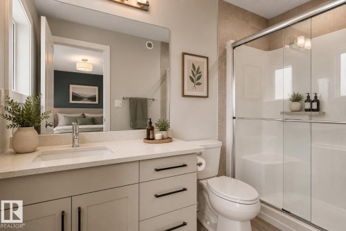 Vanity with an integrated sink, quartz countertop, and black hardware - 2355 Kelly Circle Circle Sw, Edmonton, AB - Indoor Photo Showing Bathroom