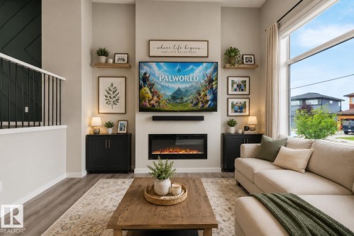Integrated electric fireplace with hearth, built-in cabinetry, wood-finish flooring, and expansive windows - 2355 Kelly Circle Circle Sw, Edmonton, AB - Indoor Photo Showing Living Room With Fireplace