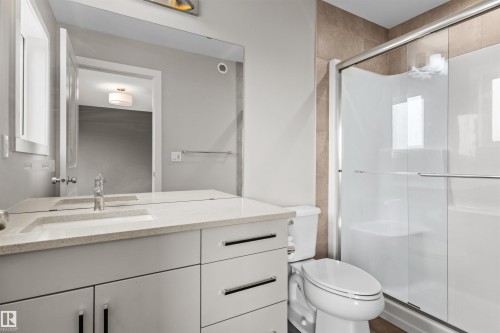 Vanity with integrated sink and quartz countertop - 2355 Kelly Circle Circle Sw, Edmonton, AB - Indoor Photo Showing Bathroom