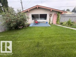 Spacious backyard featuring a large green lawn - 