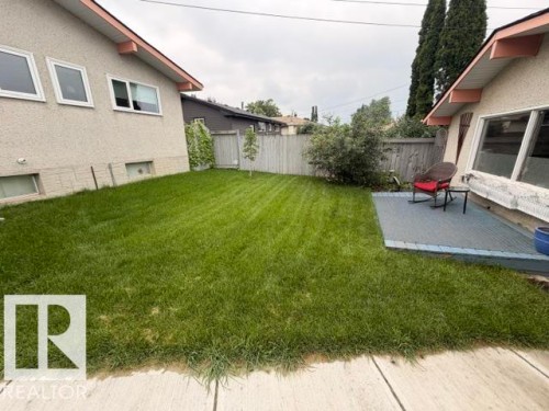 Expansive green lawn with a wooden privacy fence - 6824 89 Avenue Nw, Edmonton, AB - Outdoor