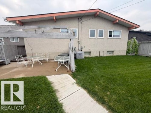 Concrete patio area with a wooden pergola structure - 6824 89 Avenue Nw, Edmonton, AB - Outdoor