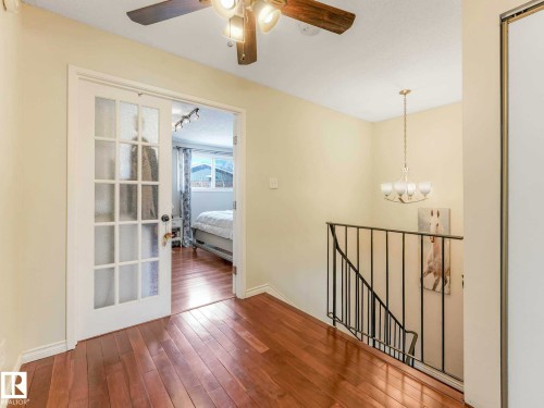 Hardwood-style flooring throughout - 13405 40 St Nw, Edmonton, AB - Indoor Photo Showing Other Room