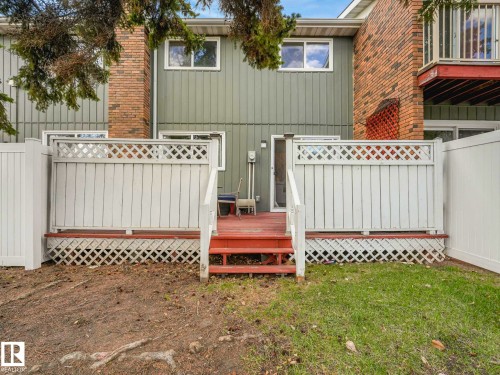 Private deck with white lattice fencing, featuring steps to a partially landscaped yard - 13405 40 St Nw, Edmonton, AB - Outdoor With Exterior