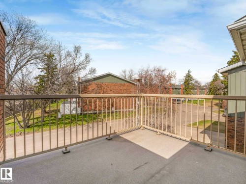 Private balcony with a light-colored railing and a gray concrete surface - 13405 40 St Nw, Edmonton, AB - Outdoor With Balcony
