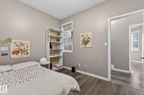 Wood-finish flooring, neutral wall paint, and white trim - #103 8108 109 St Nw, Edmonton, AB 
