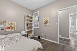 Wood-finish flooring, neutral wall paint, and white trim - 