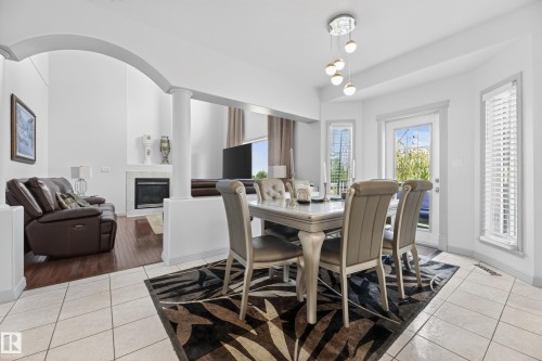 979 Hollingsworth Bend Nw, Edmonton, AB - Indoor Photo Showing Dining Room With Fireplace