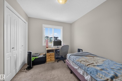 Neutral wall color with textured carpeting - 1927 51 Street Sw, Edmonton, AB - Indoor Photo Showing Bedroom