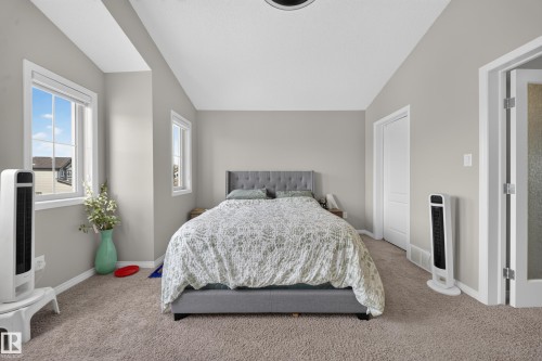Carpeted flooring, multiple windows, white trim, and a white interior door - 1927 51 Street Sw, Edmonton, AB - Indoor Photo Showing Bedroom