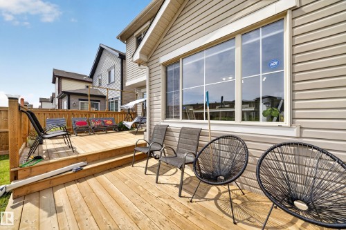 Expansive wood-plank deck with a privacy fence, large picture window, and siding exterior - 1927 51 Street Sw, Edmonton, AB - Outdoor With Deck Patio Veranda