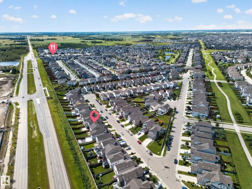 Residential community featuring uniform housing styles, arterial road access, and green spaces - 1927 51 Street Sw, Edmonton, AB - Outdoor With View