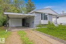 Siding exterior with a carport and an attached garage - 9712 162 St Nw, Edmonton, AB  - Outdoor 