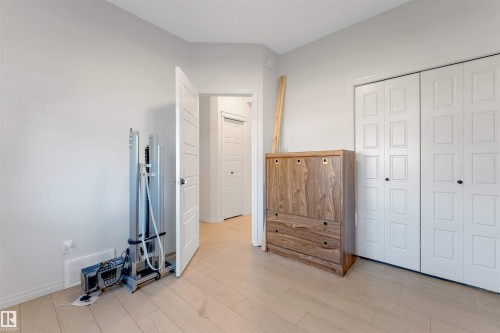 Wood-finish flooring, white walls, and a white interior door - 1263 Watt Drive Sw, Edmonton, AB - Indoor