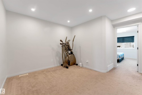 Recessed lighting, light-toned carpeting, and white painted walls - 1263 Watt Drive Sw, Edmonton, AB - Indoor