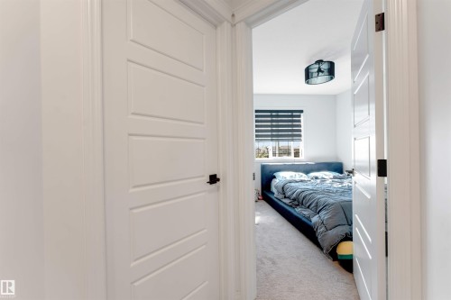 White paneled interior doors with matte black hardware - 1263 Watt Drive Sw, Edmonton, AB - Indoor Photo Showing Bedroom
