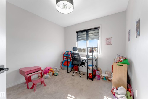 Neutral-toned walls, plush carpeting, and a window with blinds - 1263 Watt Drive Sw, Edmonton, AB - Indoor