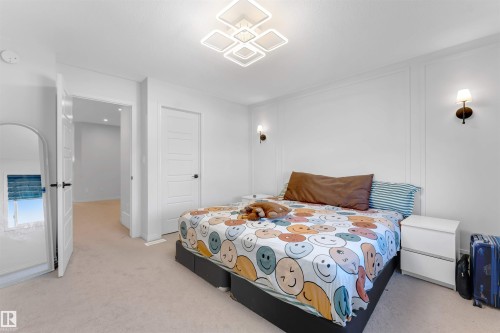 Wall paneling with integrated sconce lighting - 1263 Watt Drive Sw, Edmonton, AB - Indoor Photo Showing Bedroom