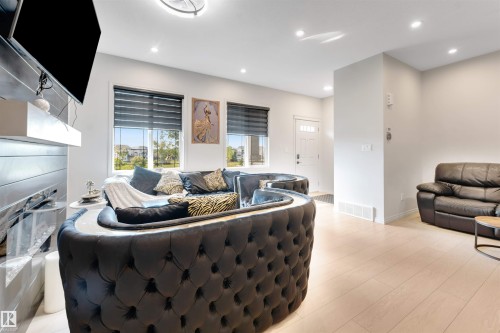 Recessed lighting, light wood-finish flooring, white walls, and a white entry door with frosted glass inserts - 1263 Watt Drive Sw, Edmonton, AB - Indoor