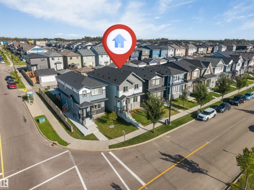 Corner-lot modern two-story residence featuring a contemporary exterior with mixed cladding materials, large multi-pane windows, and defined architectural lines - 1263 Watt Drive Sw, Edmonton, AB - Outdoor With View