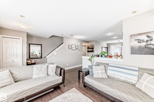 Recessed ceiling lighting, wood-finish flooring, half-wall partition, and paneled interior doors - #138 655 Tamarack Rd Nw, Edmonton, AB - Indoor Photo Showing Bedroom