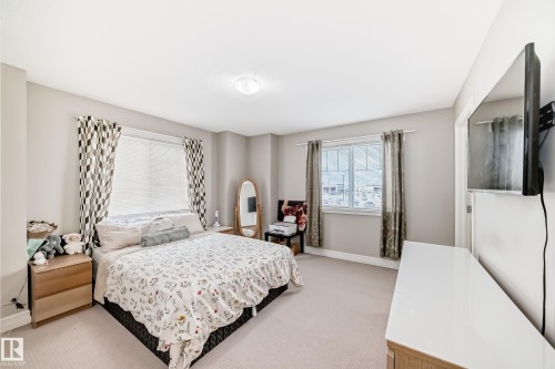 Recessed lighting, light-colored carpeting, and light-toned walls - #138 655 Tamarack Rd Nw, Edmonton, AB - Indoor Photo Showing Bedroom