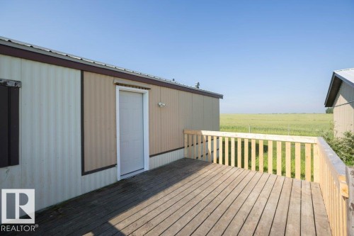 Wood deck with light-toned railings - 26417 Twp Rd 582, Rural Westlock County, AB - Outdoor With Deck Patio Veranda With Exterior