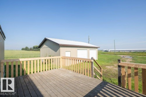 Wood-finish deck with a natural wood railing - 26417 Twp Rd 582, Rural Westlock County, AB - Outdoor With Deck Patio Veranda With Exterior