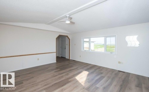 Wood-finish flooring throughout, white walls, and a multi-pane window - 26417 Twp Rd 582, Rural Westlock County, AB - Indoor Photo Showing Other Room