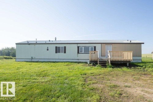 Metal roofing, siding exterior, expansive lawn, wood deck, wood railings - 26417 Twp Rd 582, Rural Westlock County, AB - Outdoor