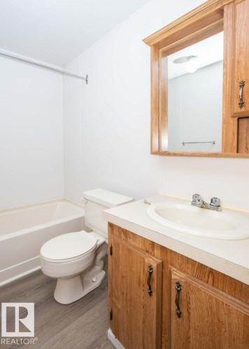 White bathtub and toilet - 26417 Twp Rd 582, Rural Westlock County, AB - Indoor Photo Showing Bathroom