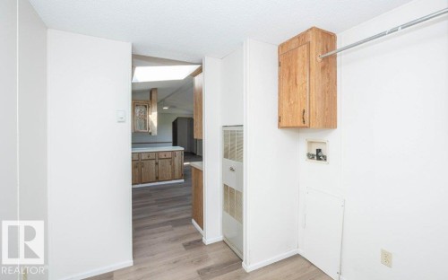 Dedicated laundry area with a wall-mounted cabinet and utility hookups - 26417 Twp Rd 582, Rural Westlock County, AB - Indoor Photo Showing Other Room