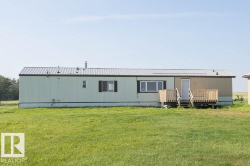 Corrugated metal roof, multi-color siding, multiple windows, front entry door, and wood deck - 26417 Twp Rd 582, Rural Westlock County, AB - Outdoor