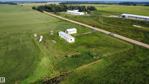 Extensive rural property featuring a paved road, multiple outbuildings, and cultivated fields - 26417 Twp Rd 582, Rural Westlock County, AB - Outdoor With View