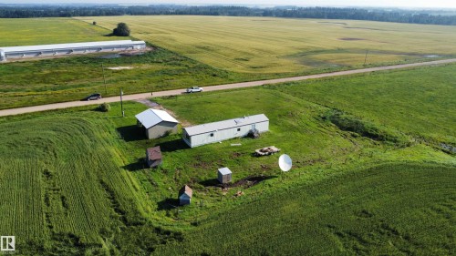Expansive green acreage with two primary structures and two smaller outbuildings - 26417 Twp Rd 582, Rural Westlock County, AB - Outdoor With View