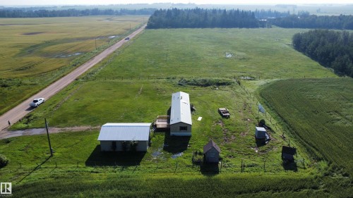 Expansive rural property featuring a main residence, detached outbuilding, and additional small structures - 26417 Twp Rd 582, Rural Westlock County, AB - Outdoor With View