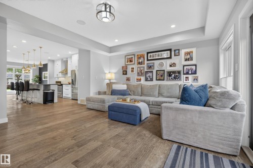 Open-concept living space featuring wood-finish flooring, recessed lighting, and a kitchen with an island and pendant lighting - 11018 122 Street Nw, Edmonton, AB - Indoor Photo Showing Living Room
