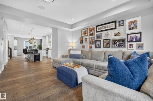 Open-concept living area with wood-finish flooring, recessed lighting, and a tray ceiling - 11018 122 Street Nw, Edmonton, AB - Indoor Photo Showing Living Room