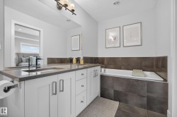Dual vanity with undermount sinks, stone countertop, and contemporary faucets - 
