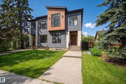 Modern exterior with gray stucco, natural stone accents, brick cladding, and black-framed windows - 11018 122 Street Nw, Edmonton, AB - Outdoor With Facade