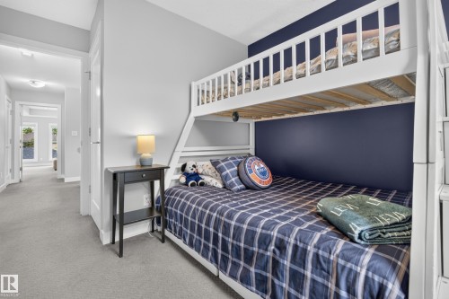 White bunk bed with a built-in ladder and guardrails - 11018 122 Street Nw, Edmonton, AB - Indoor Photo Showing Bedroom