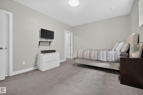 Recessed lighting, light gray wall finishes, gray carpet flooring, and white trim - 11018 122 Street Nw, Edmonton, AB - Indoor Photo Showing Bedroom