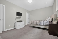 Recessed lighting, light gray wall finishes, gray carpet flooring, and white trim - 